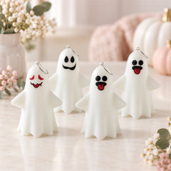 Four white ghost figures with distinct playful faces and hanging rings stand on a light-colored surface.
