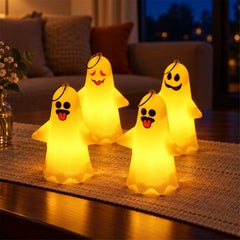 Four glowing ghost-shaped LED lights with different facial expressions illuminate a dark room.
