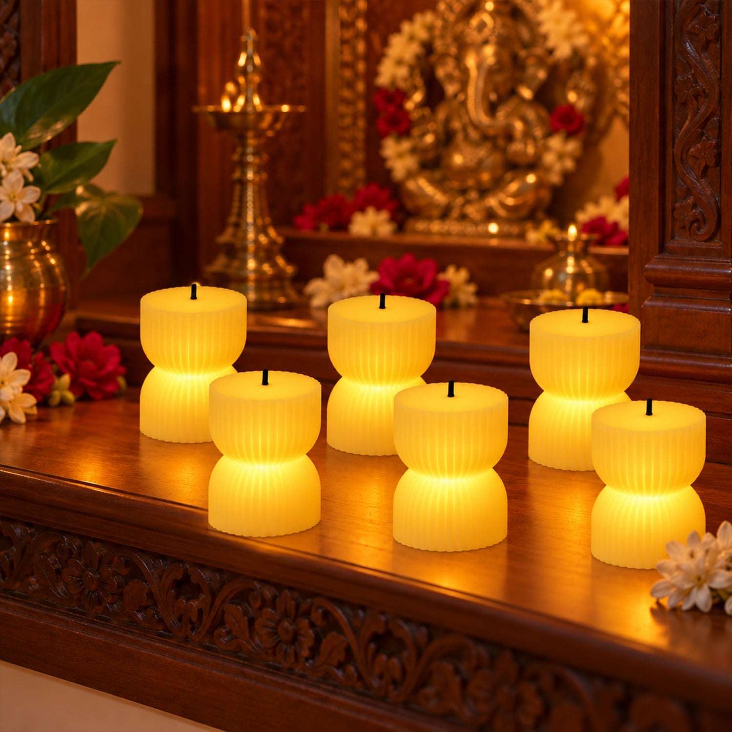 Six glowing ribbed LED candles on a carved wooden ledge, with a golden idol and flowers in the background.
