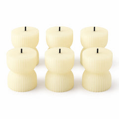 Six cream-colored ribbed LED candles with black wicks, arranged in two rows on a plain white background.