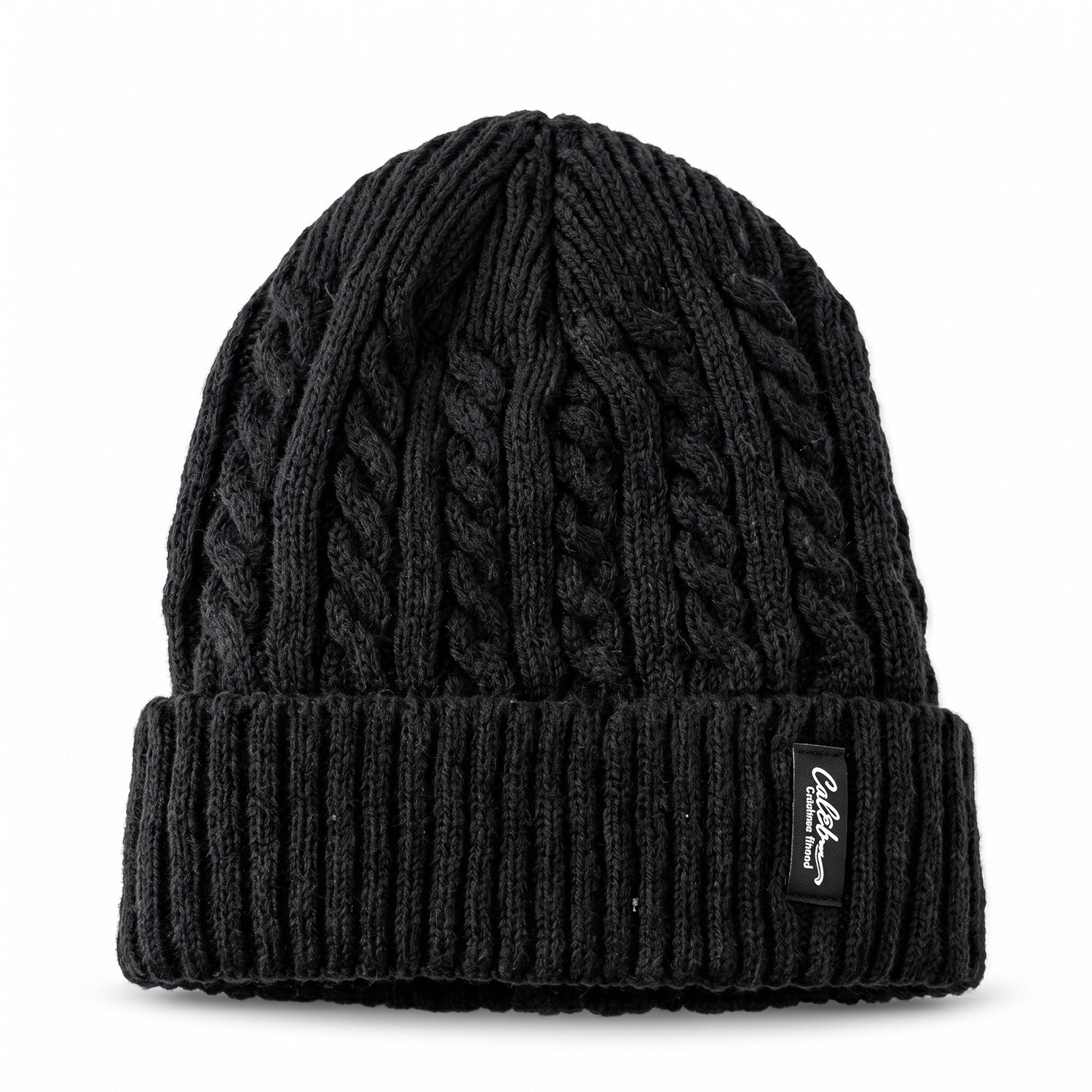 A black cable knit beanie with a textured crown and ribbed folded cuff, featuring a rectangular brand tag.
