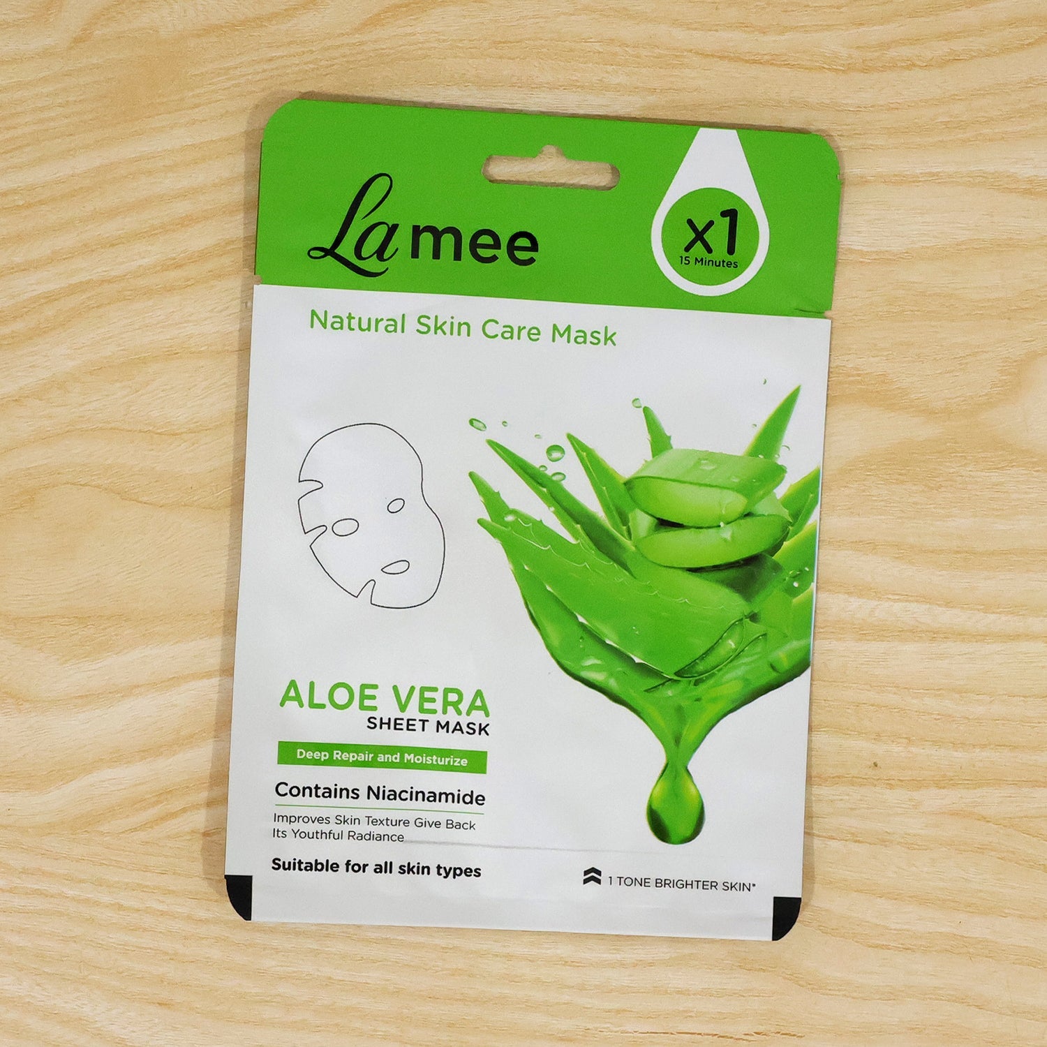 Person relaxing with an aloe vera facial sheet mask applied