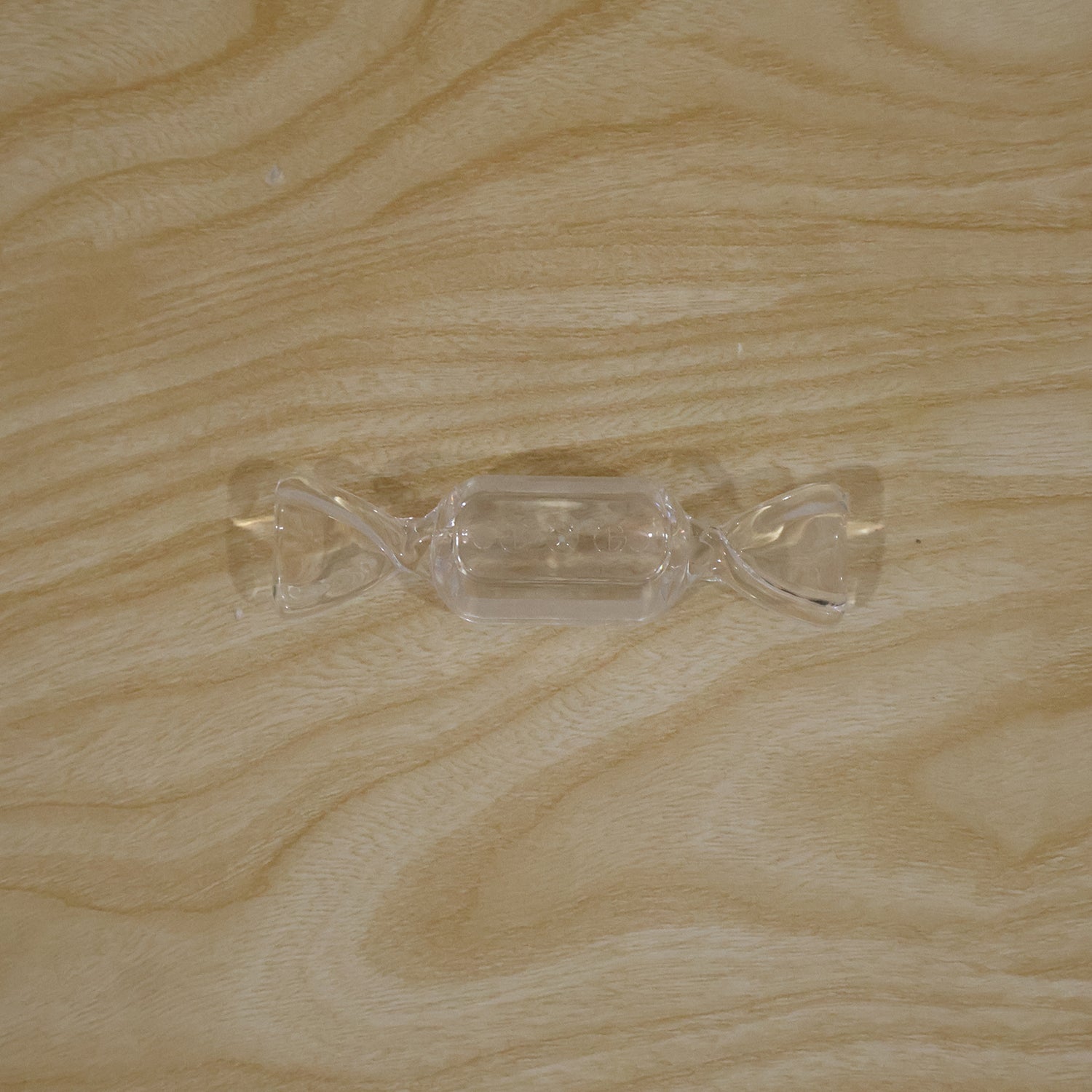 Clear candy-shaped jewellery storage box in a daily use setting