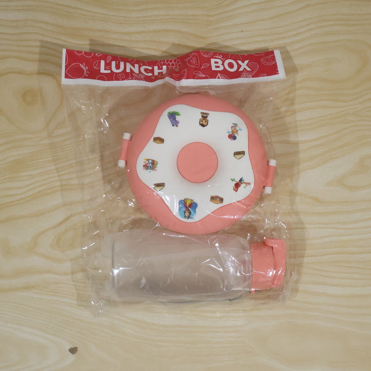 Child using kids donut lunchbox and water bottle at school