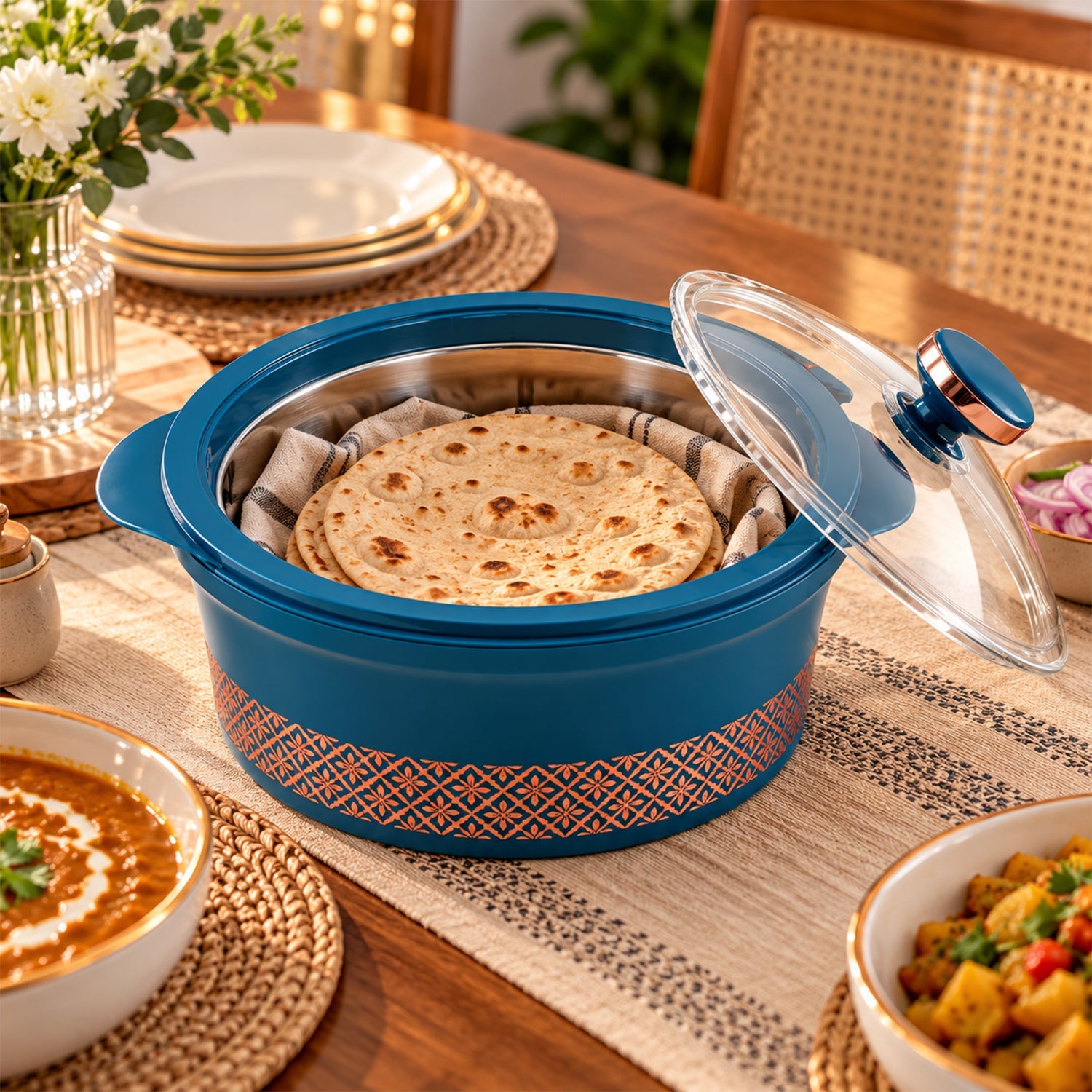 The teal casserole dish on a table, holding warm flatbread inside, with its glass lid resting beside it.
