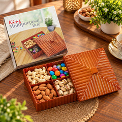 Brown four-compartment dry fruit and snack box with a ribbed lid, filled with various nuts and candies.