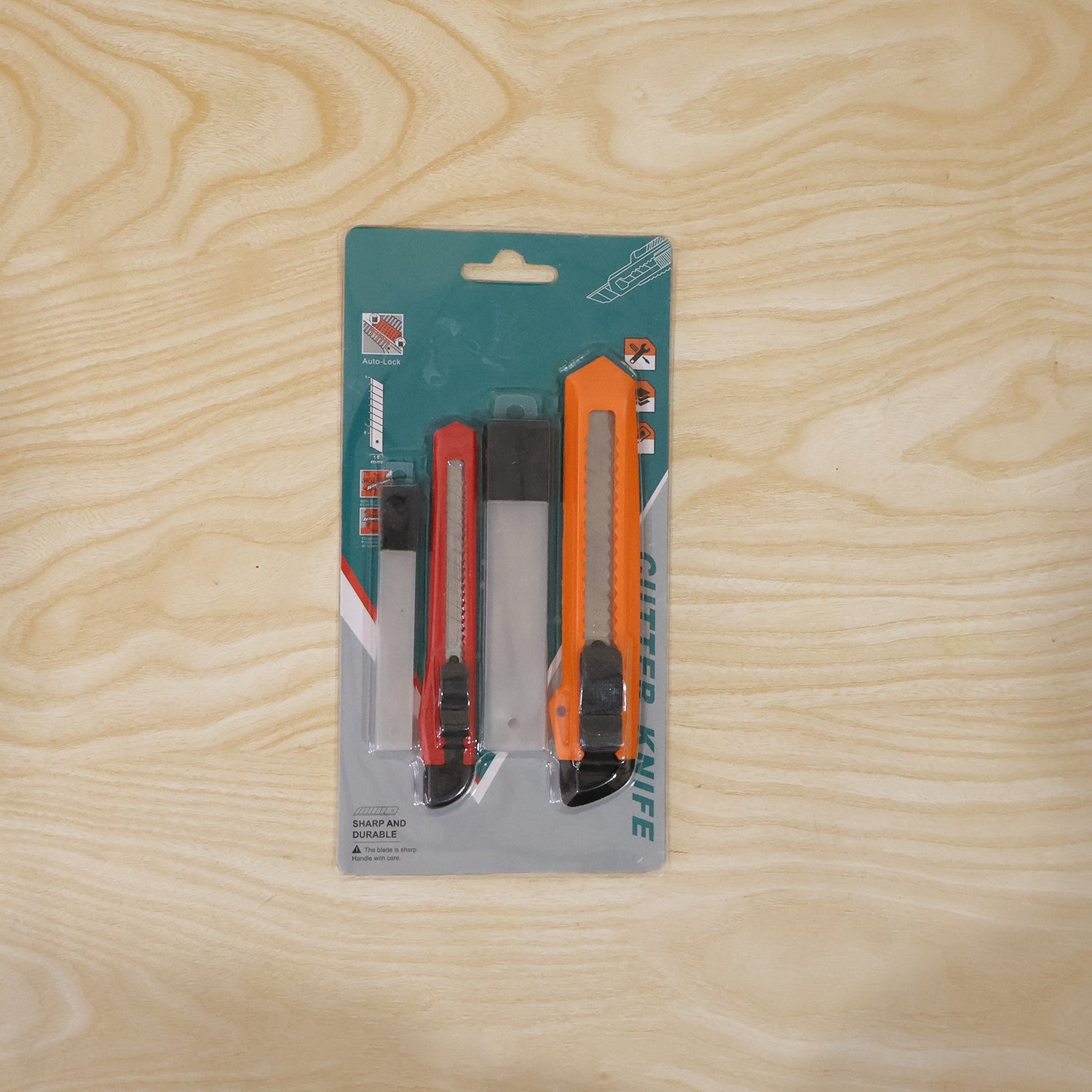 Set of utility knives displayed on workstation for DIY and packaging tasks.
