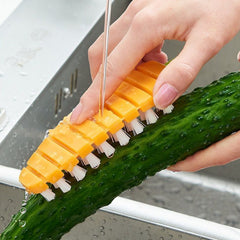 Carrot-shaped non-toxic vegetable scrubbing brush on white background