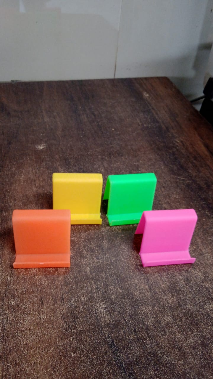 Mobile phone supported in angled stand on table