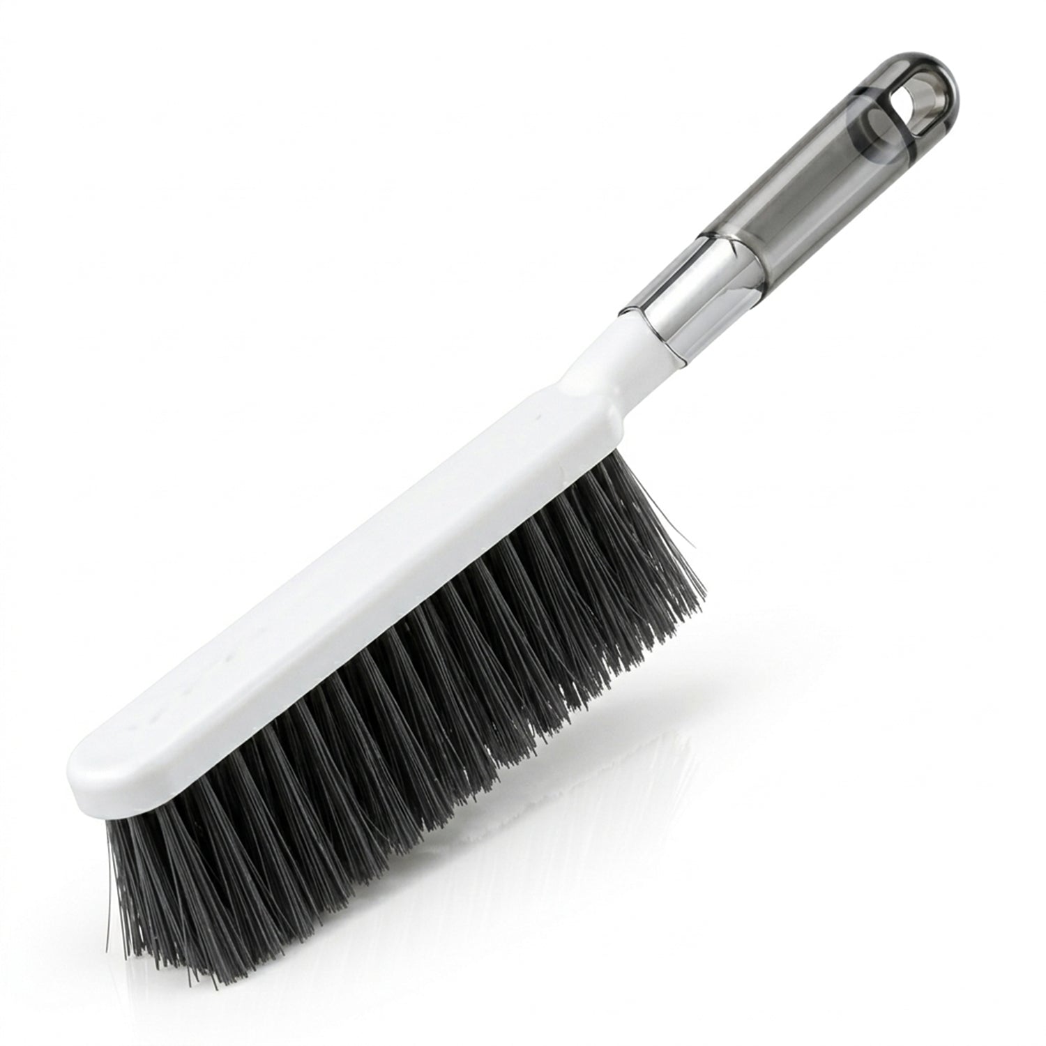 The white and gray cleaning brush with dark bristles is angled on a clean white background.
