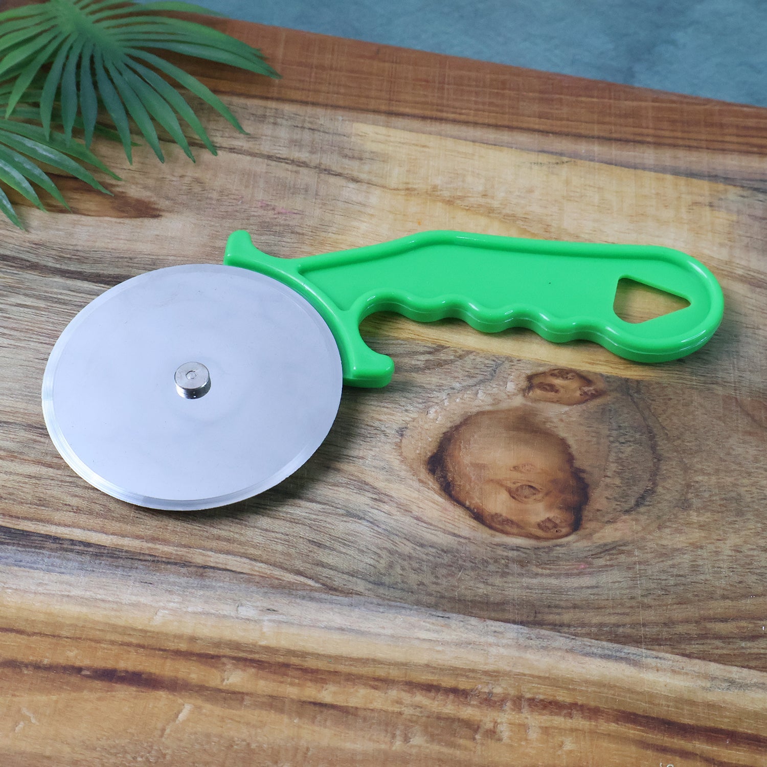 Side view of Quickslice pizza cutter on a wooden board