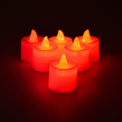 Close-up of red LED flameless tealight candle showing flickering effect