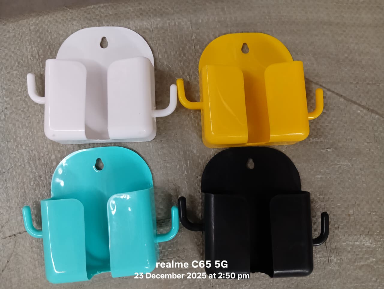 Wall-mount mobile phone holder with hook in use