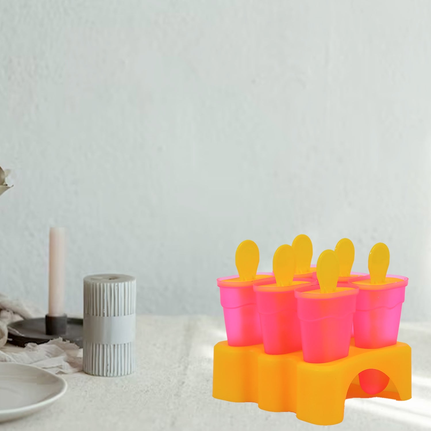 Plastic kulfi moulds with lids on kitchen counter