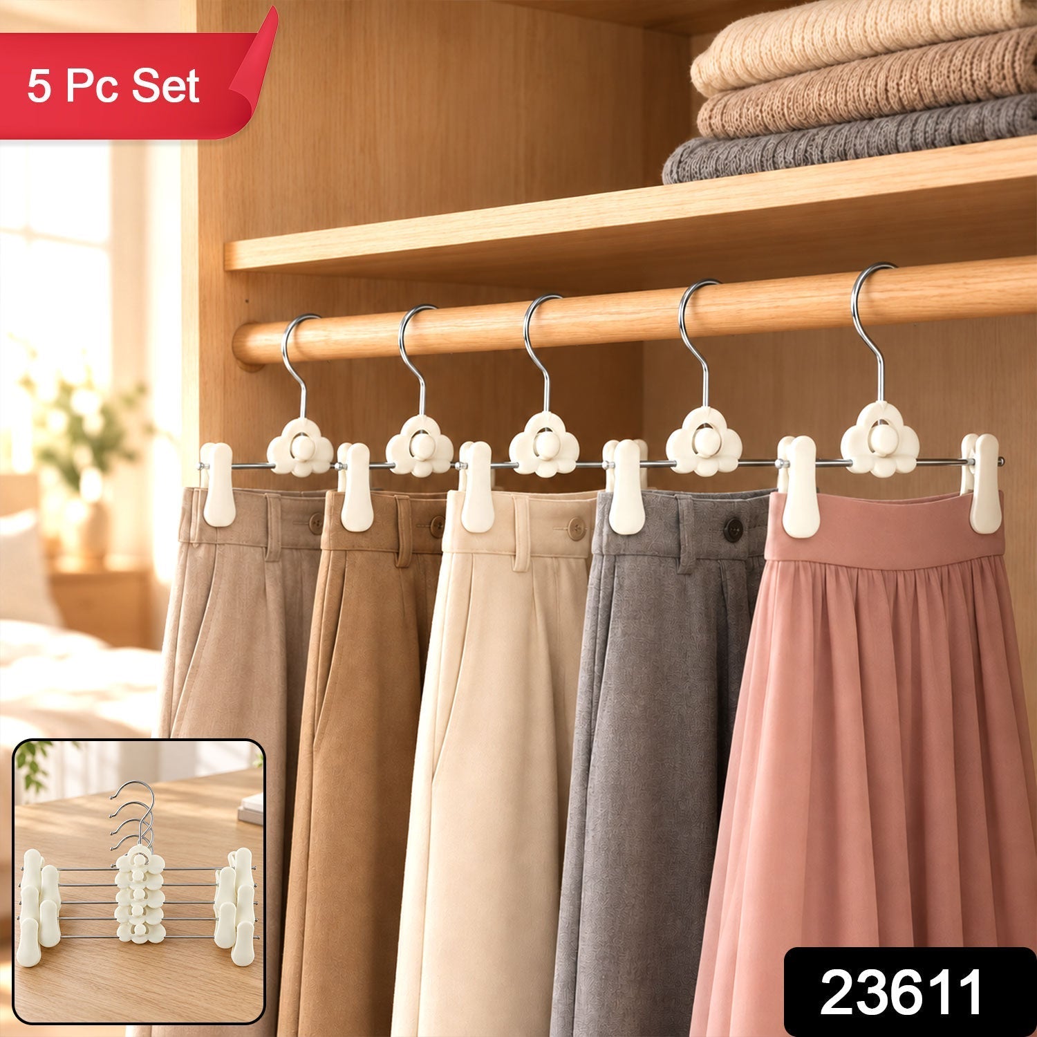 Five pairs of pants and a skirt hang on white cloud-shaped hangers inside a wooden closet, with a small inset showing