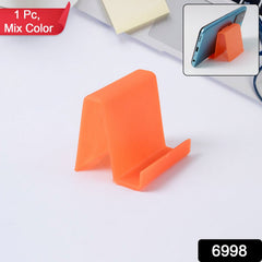 Plastic phone stand holding smartphone on desk