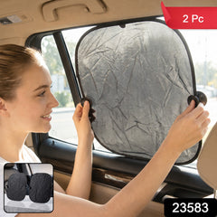 A woman installs a black foldable sunshade with suction cups on a car's side window, with a small inset showing two â€“ view 2