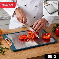 A chef cuts red pepper on a teal and metal chopping board, with an inset showing the board and herbs.