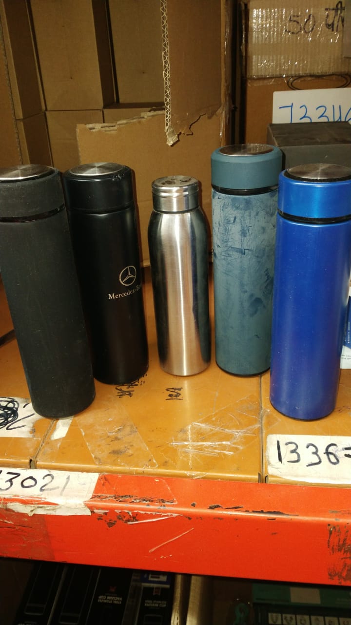 Travel-friendly stainless steel bottle being carried outdoors, ideal for adventures.