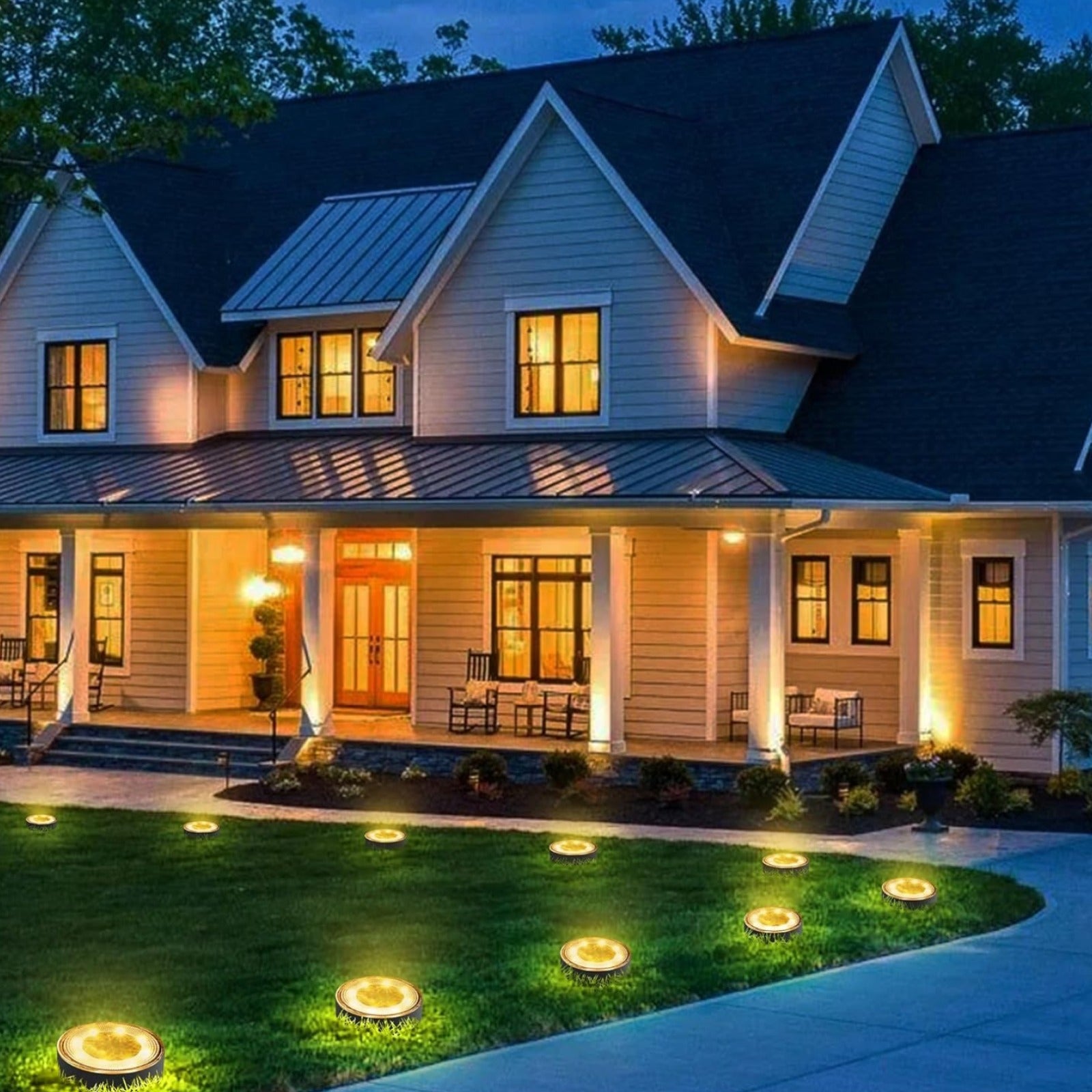 Pack of 4 solar ground lights on a garden lawn