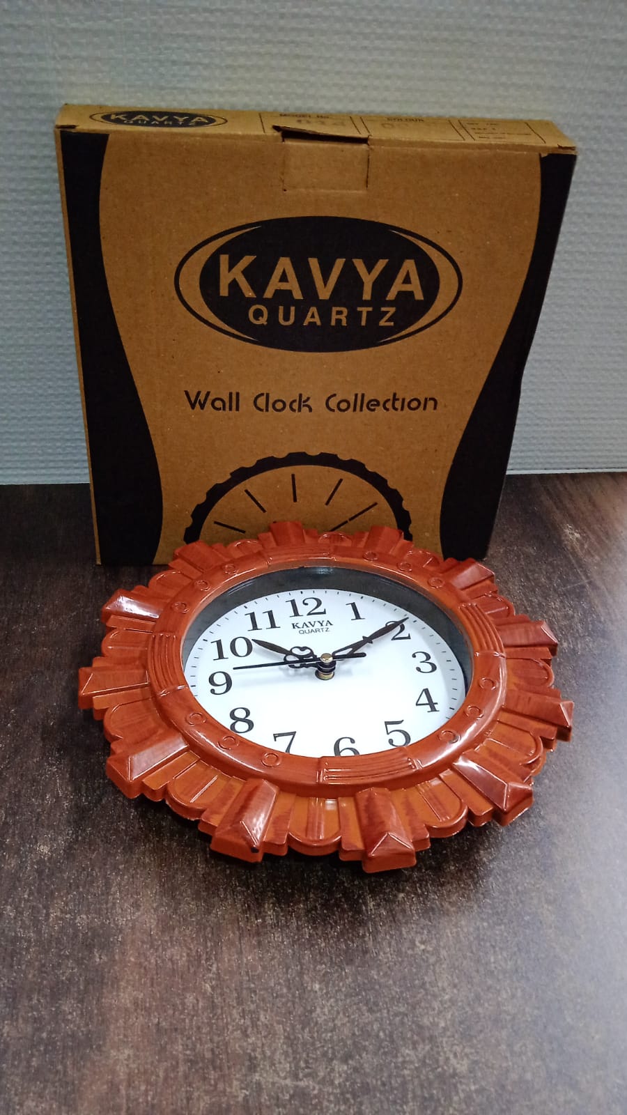 Wooden look round wall clock displayed in modern room