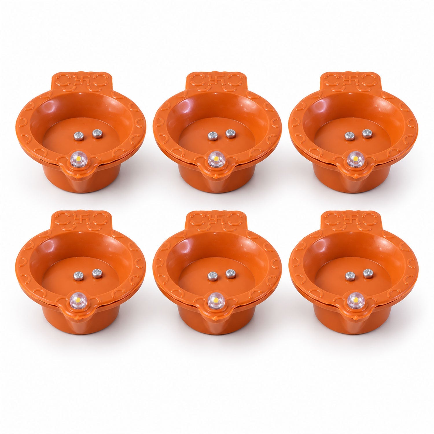 Six identical orange diyas, each with two silver sensors and a clear LED lens, are arranged on a white surface.