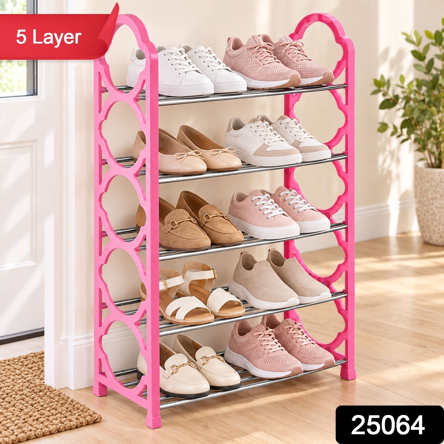 A bright pink five-layer shoe storage unit filled with an assortment of footwear, placed on a light wooden floor beside a