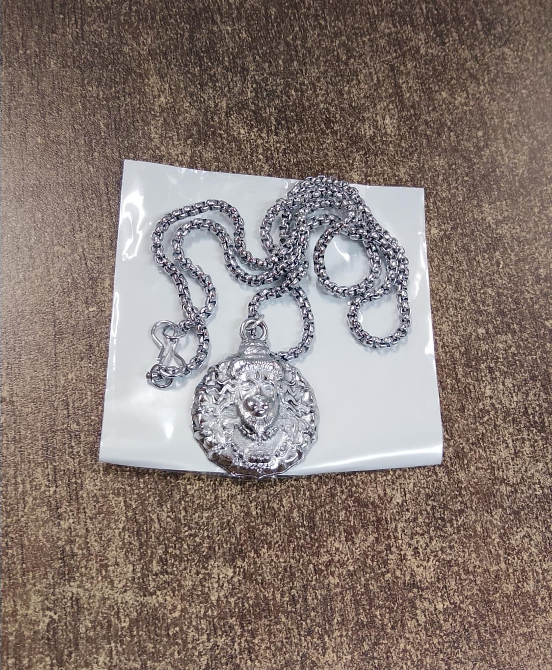 Lifestyle image of Hanuman face silver pendant necklace worn on neck