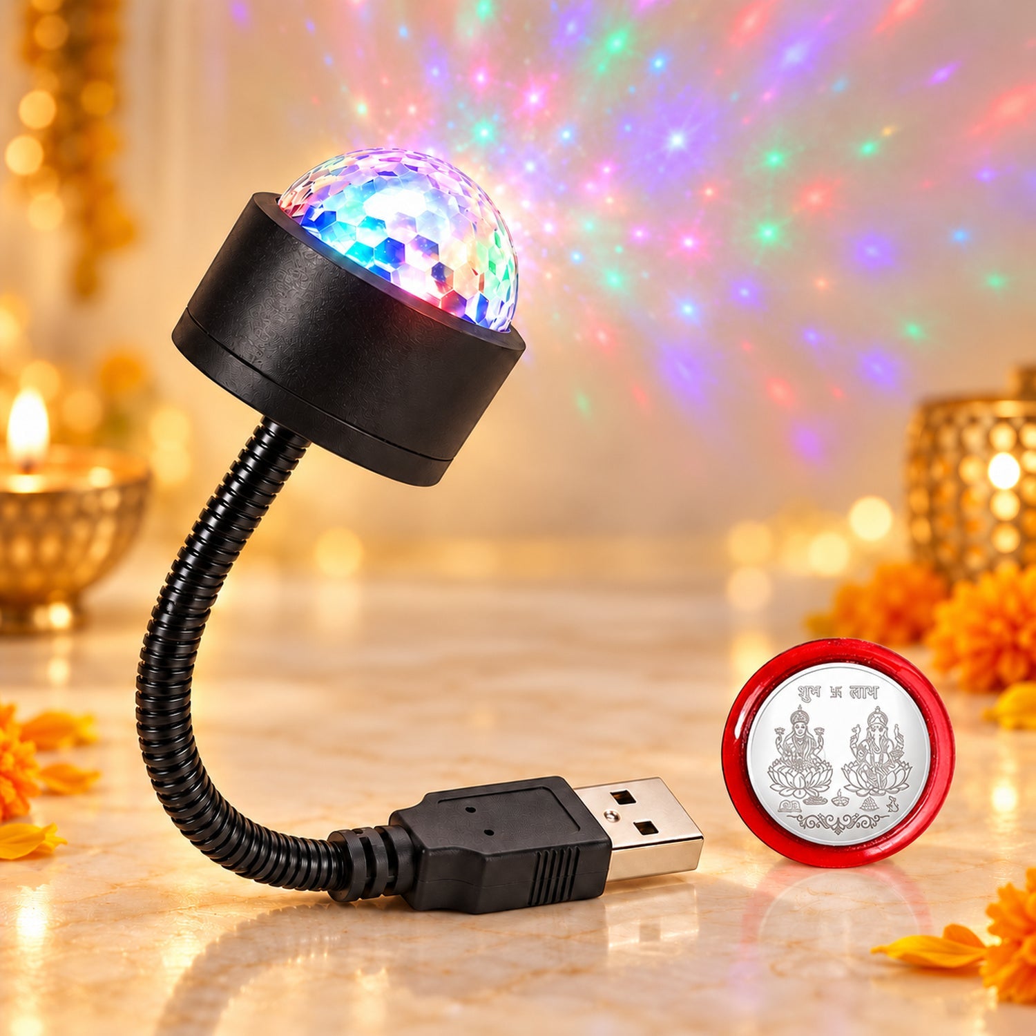A USB galaxy light projects colorful stars onto a wall, next to a red-rimmed silver coin on a reflective surface.