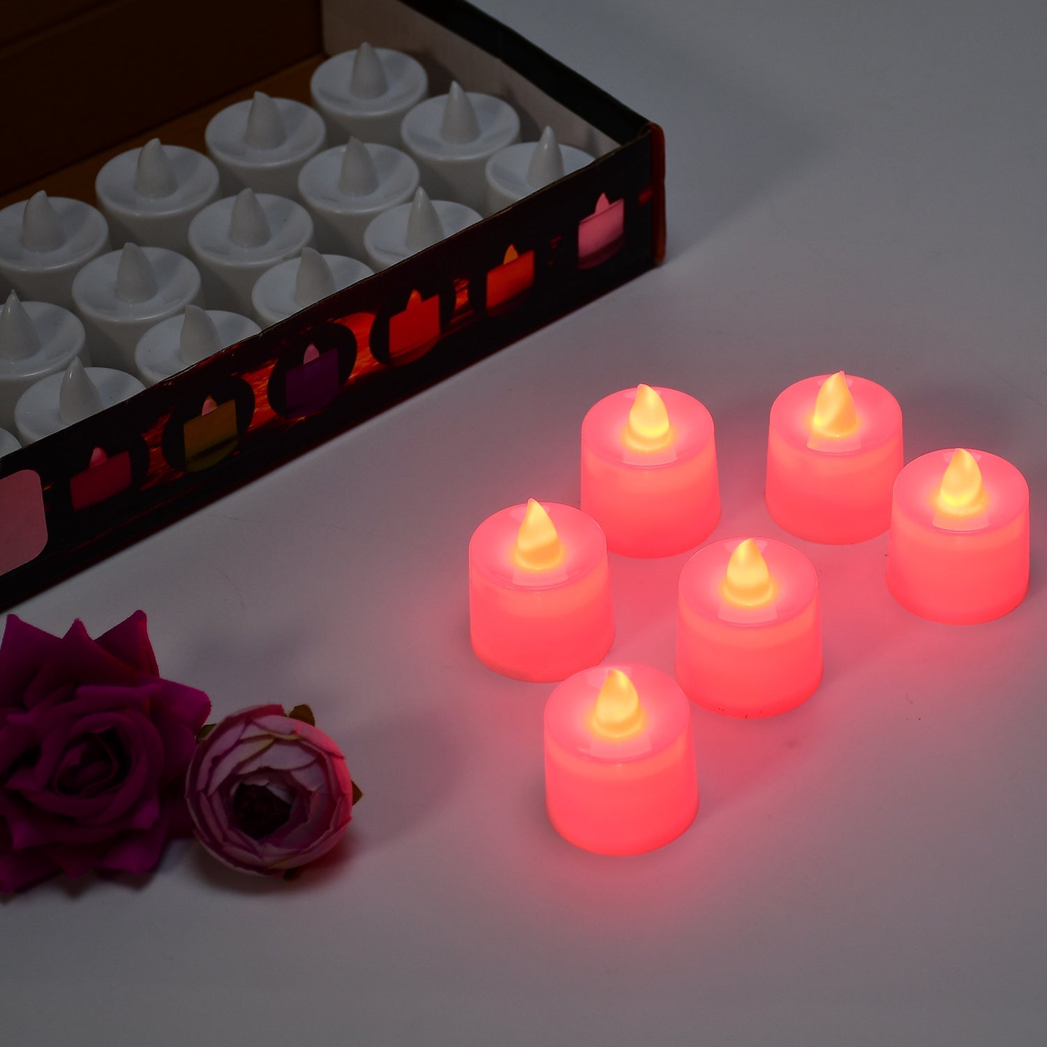 Red LED tealights creating a warm ambient light for party setting
