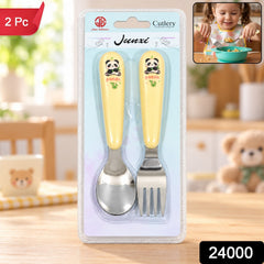 A yellow and silver panda-themed spoon and fork set is packaged in clear plastic on a wooden table, with a small image of a