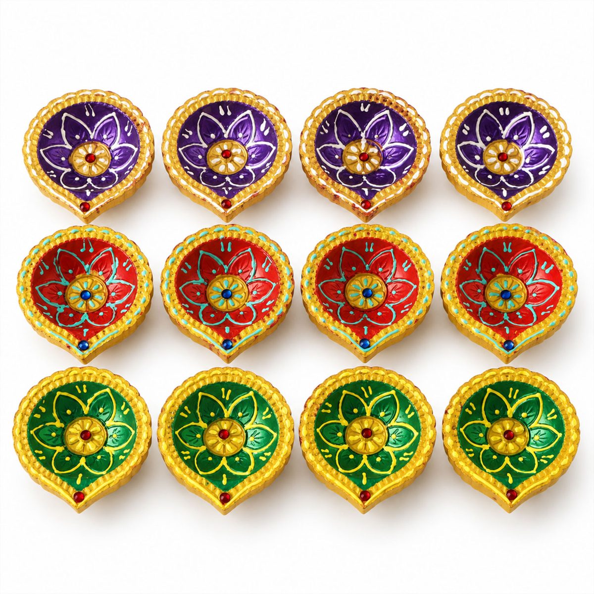 Twelve unlit painted clay diyas in purple, red, and green with gold details on a white surface.