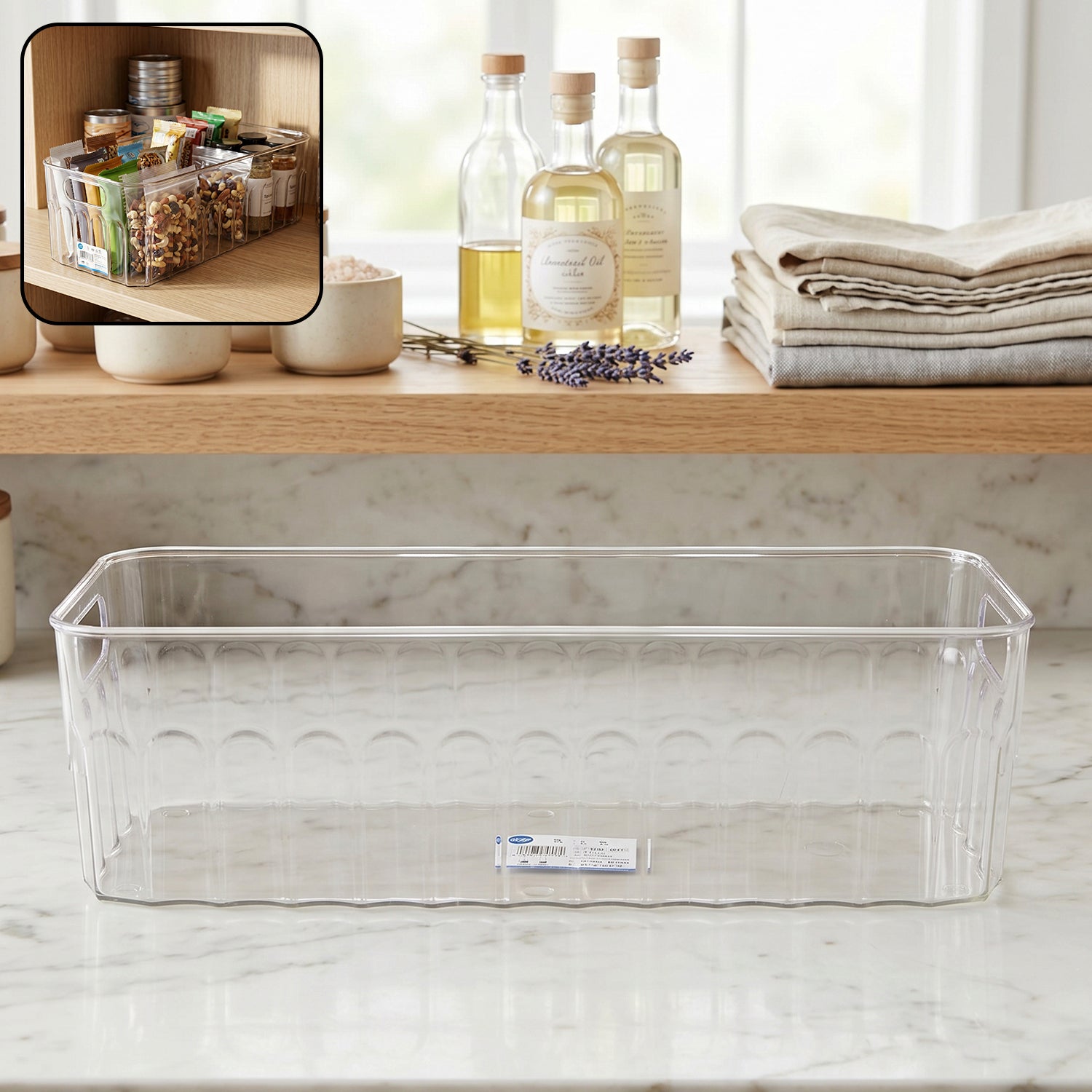 Transparent plastic fridge organizer basket with handles for easy lifting.
