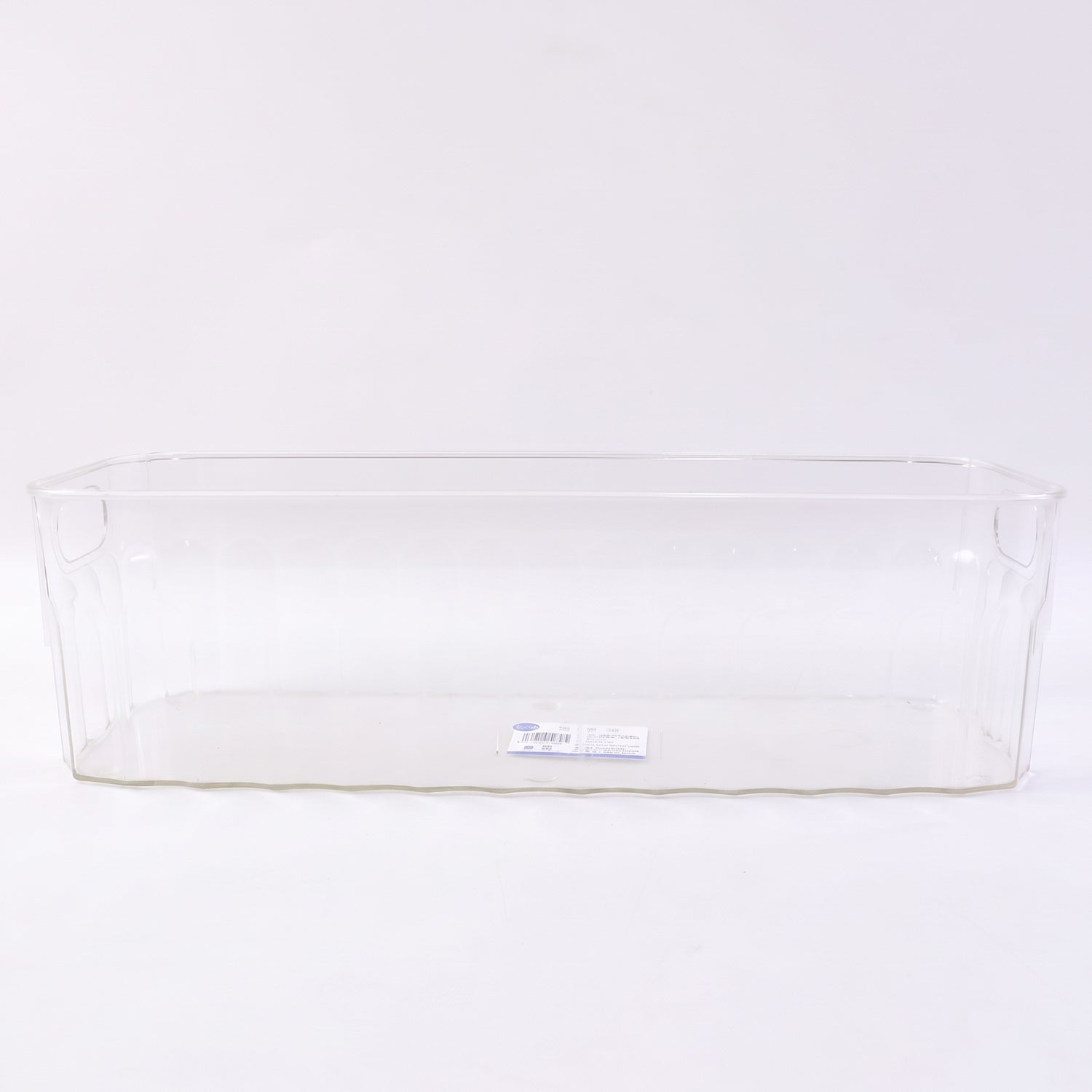 Decorative ribbed sides on a transparent storage basket for kitchen organization.