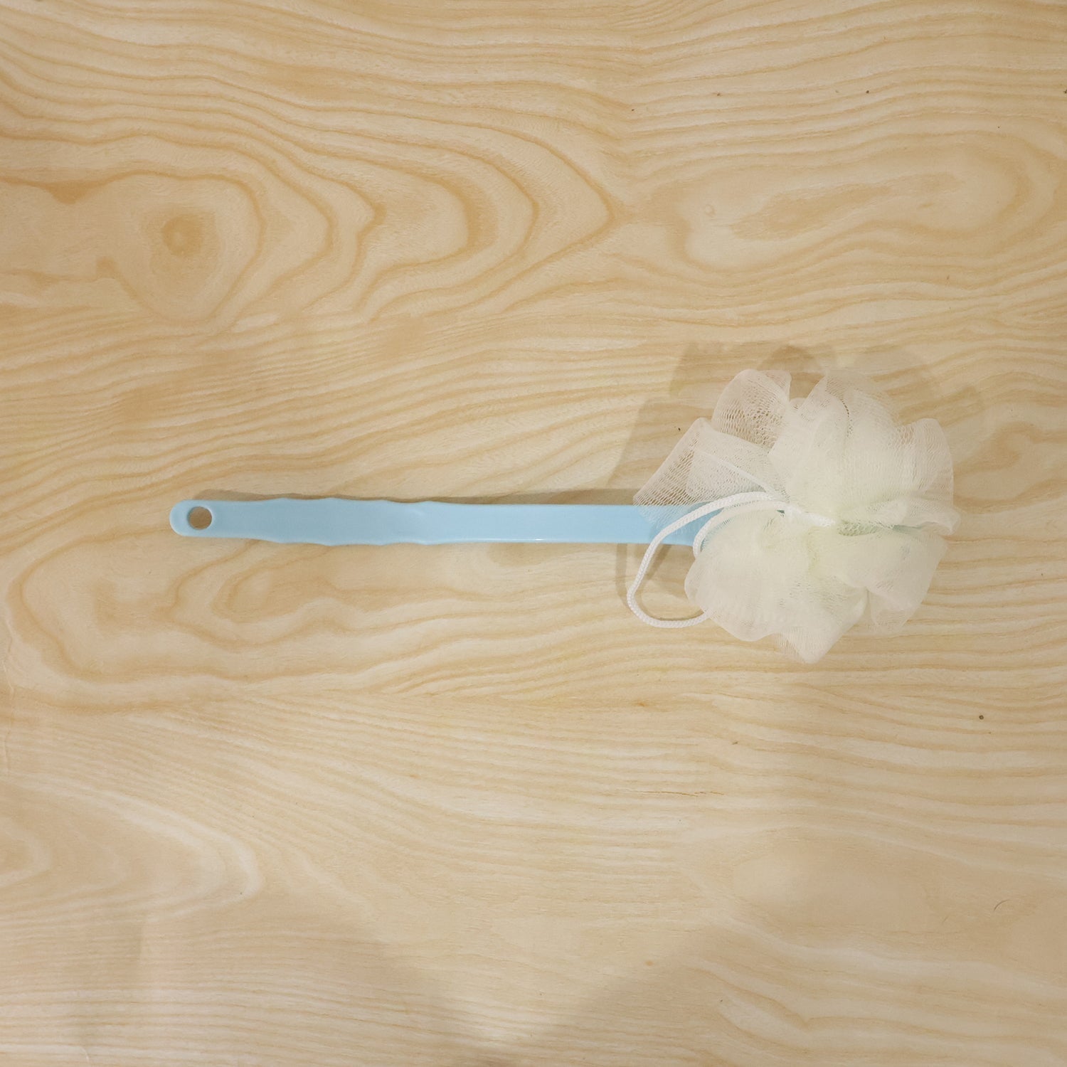 Shower brush back scrubber in use