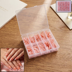 Close-up of nude pink artificial nail tips in a clear storage box