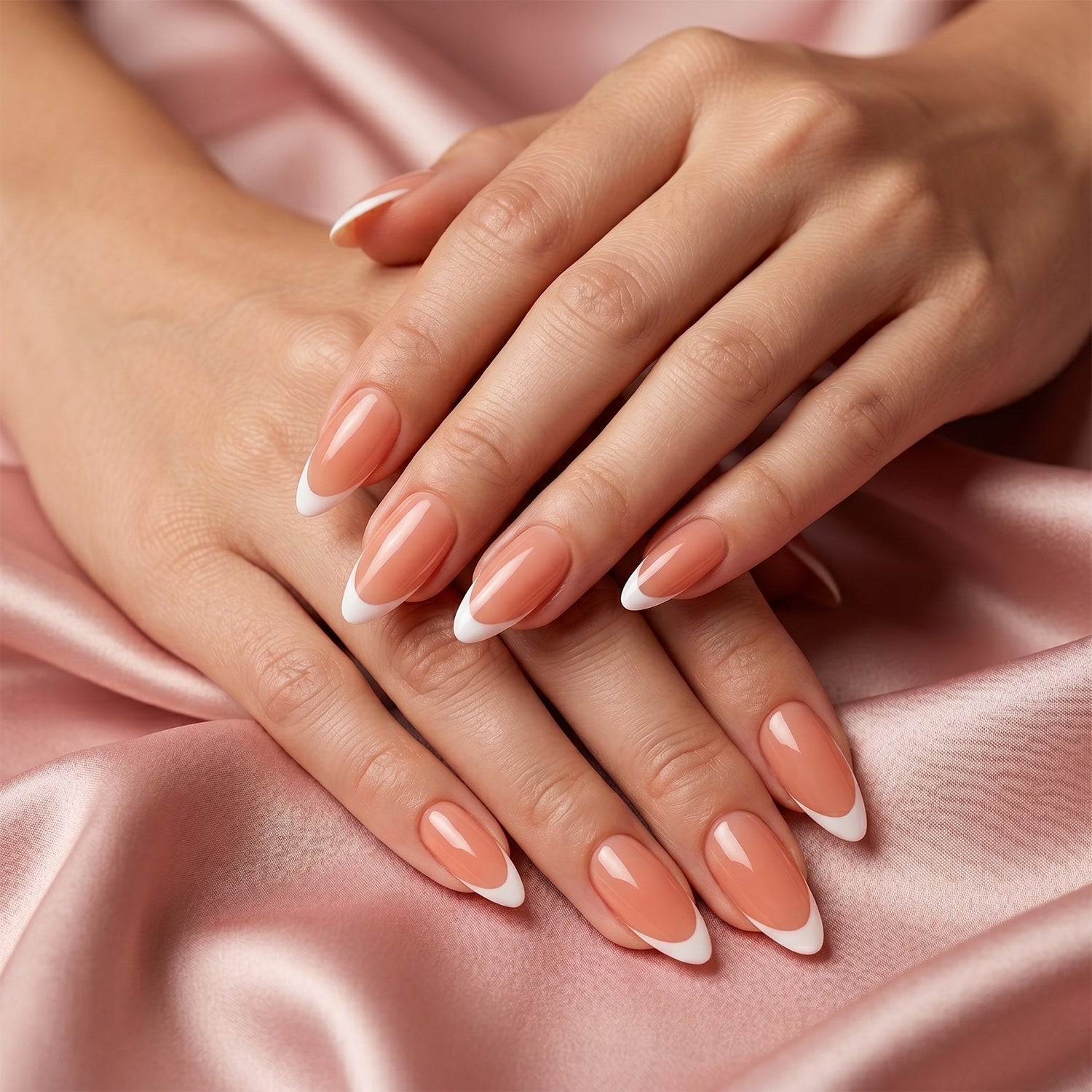 Nude pink artificial nails being shaped and painted