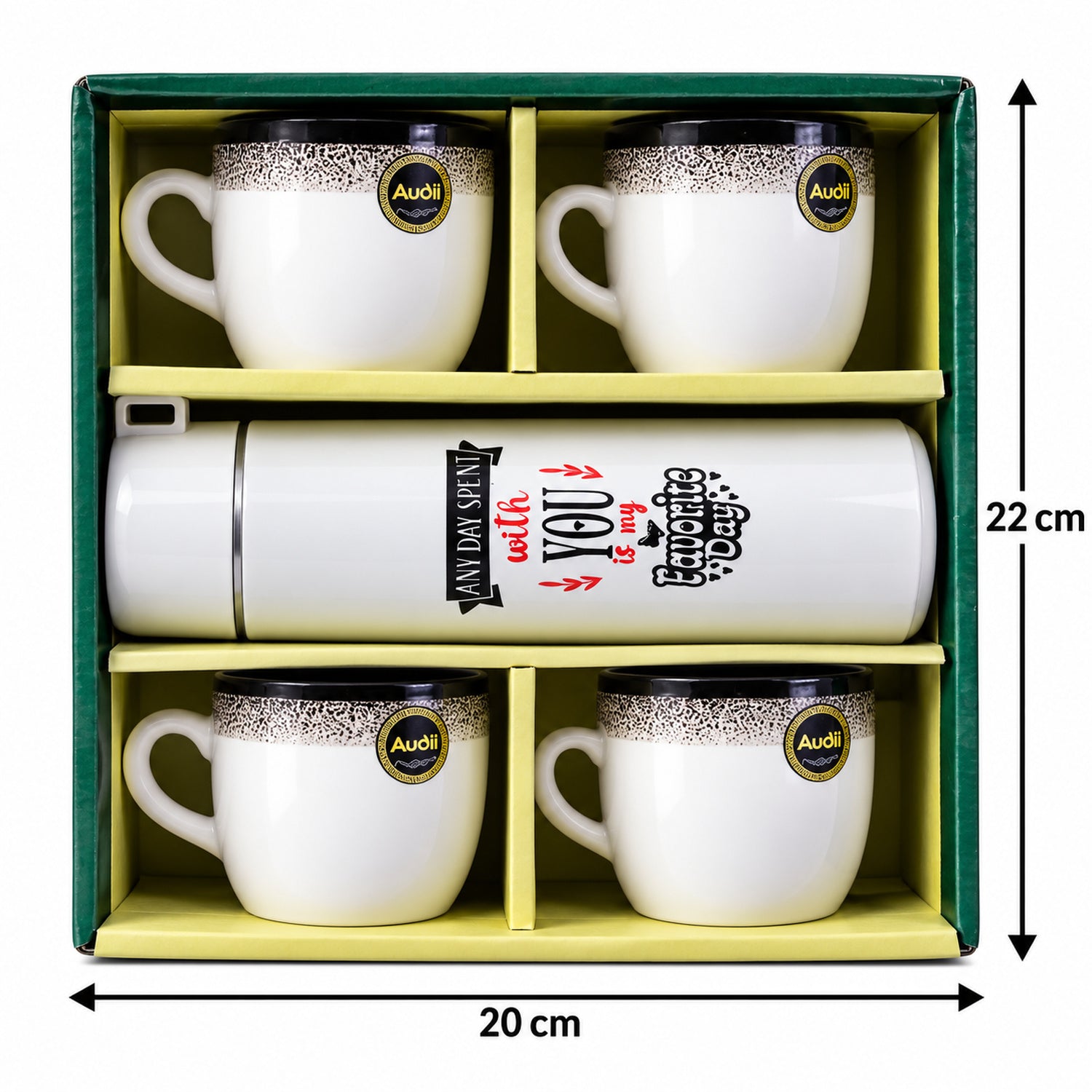 White insulated bottle and four white ceramic mugs with black speckled rims arranged on a light brown coffee table.