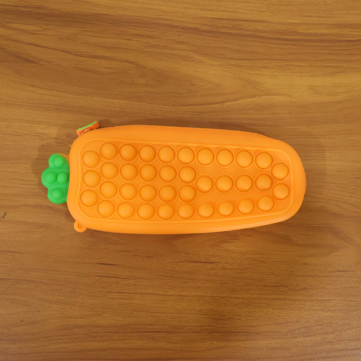Person holding Pop It silicone pencil pouch in hand