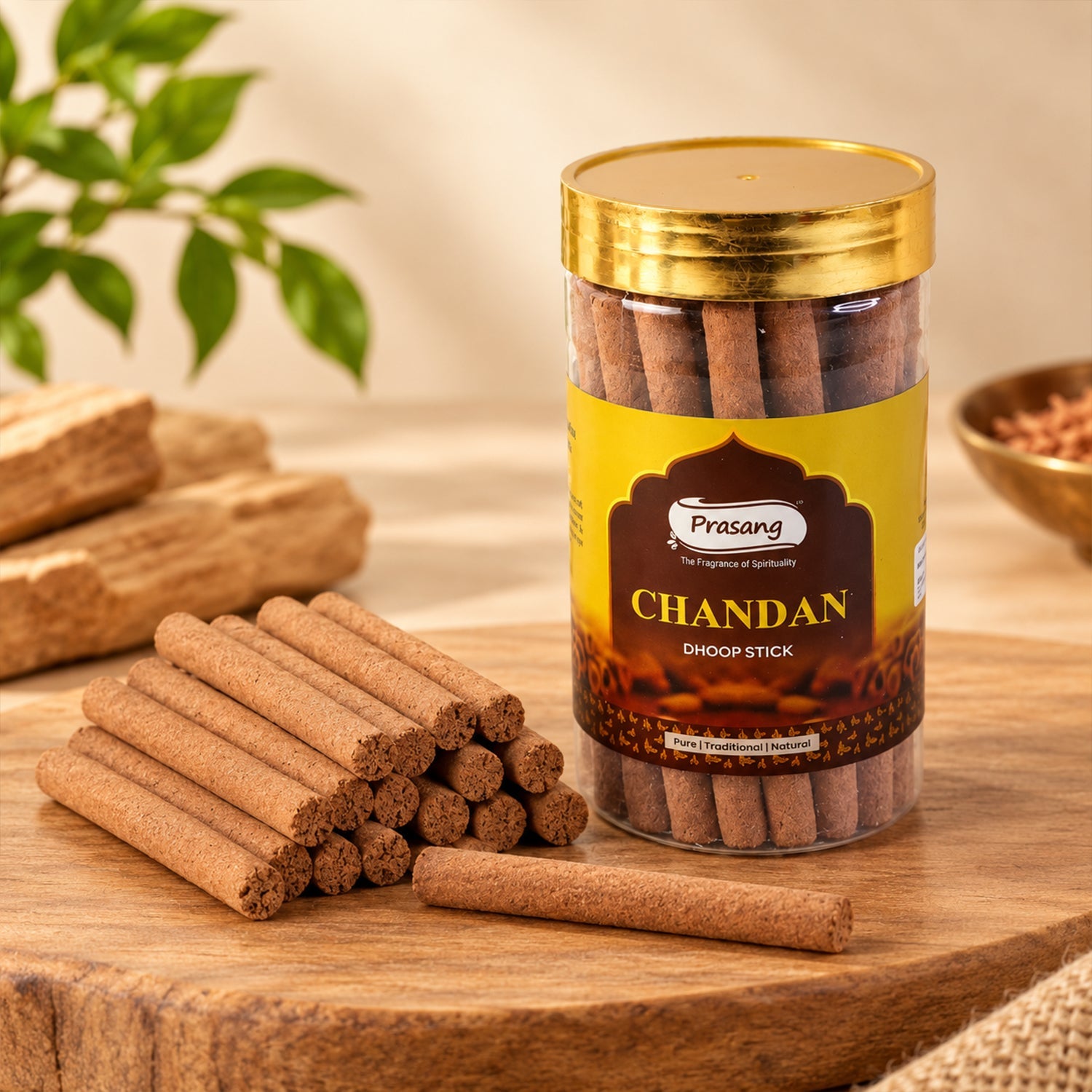 A clear jar of brown dhoop sticks stands on a wooden board, with a pile of sticks in front.