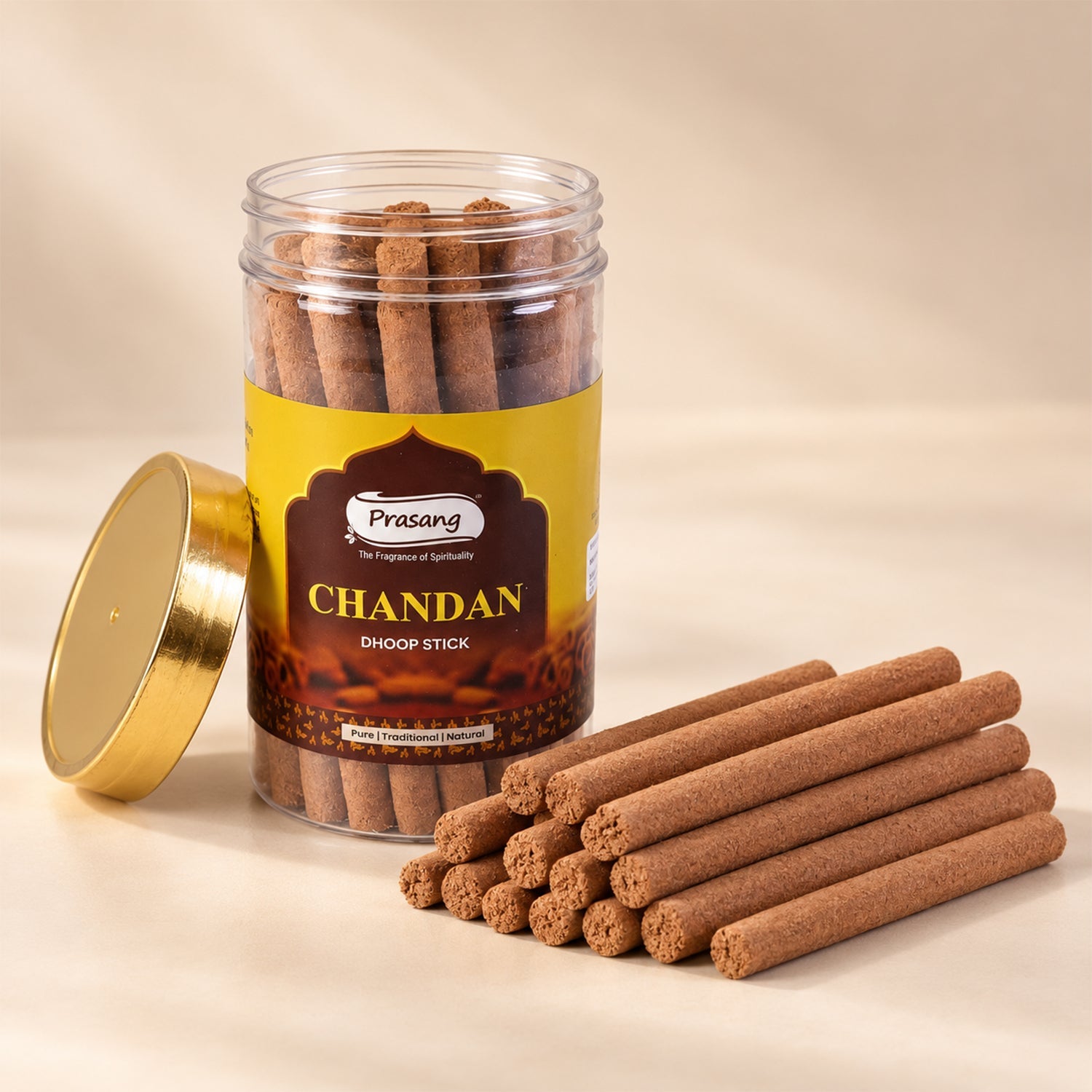 An open jar of brown dhoop sticks sits next to a neat stack of similar sticks on a light surface.