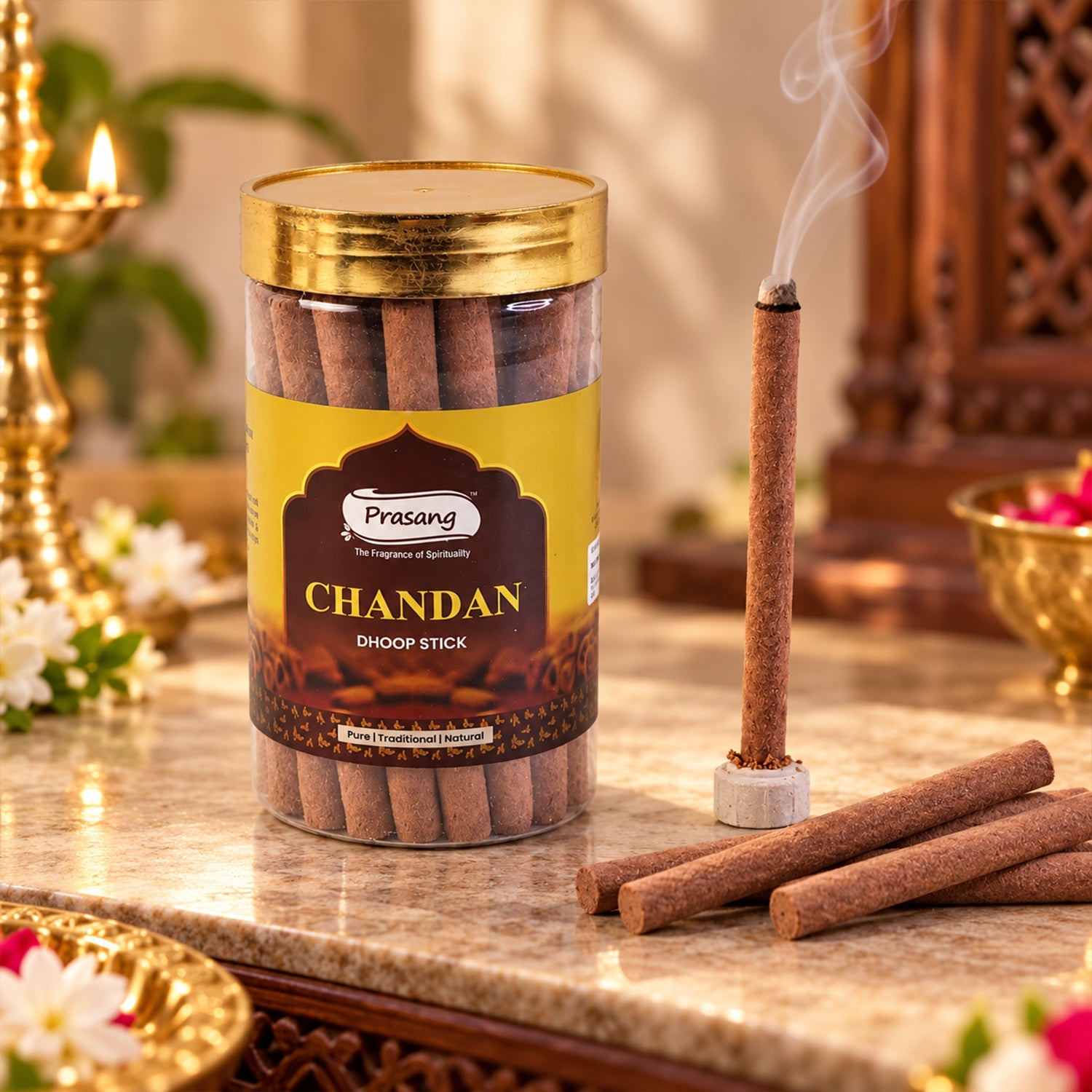 A smoking dhoop stick stands beside a jar of sticks on a marble surface, with a lit lamp in the corner.