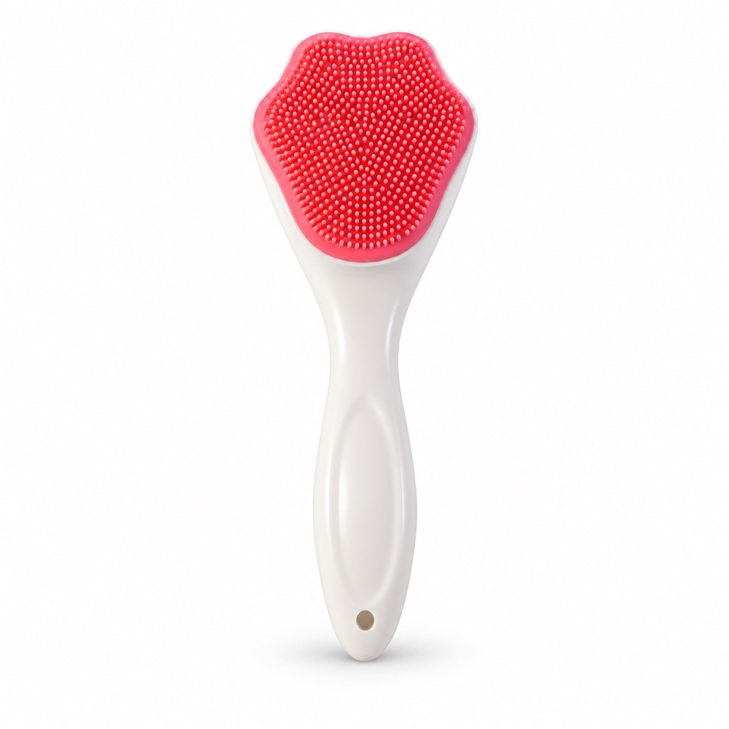 A white-handled brush with a pink, paw-shaped silicone head featuring many small bristles stands upright.