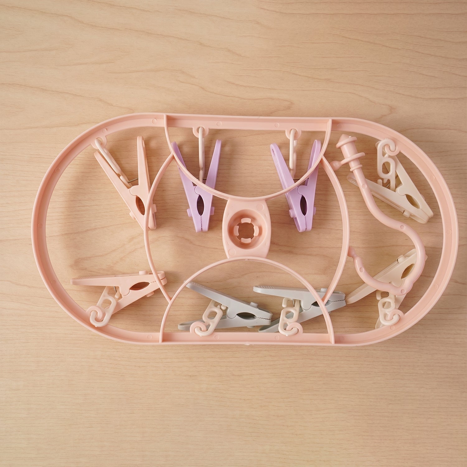 Clips set shown in use on clothing and towels for laundry drying and organization