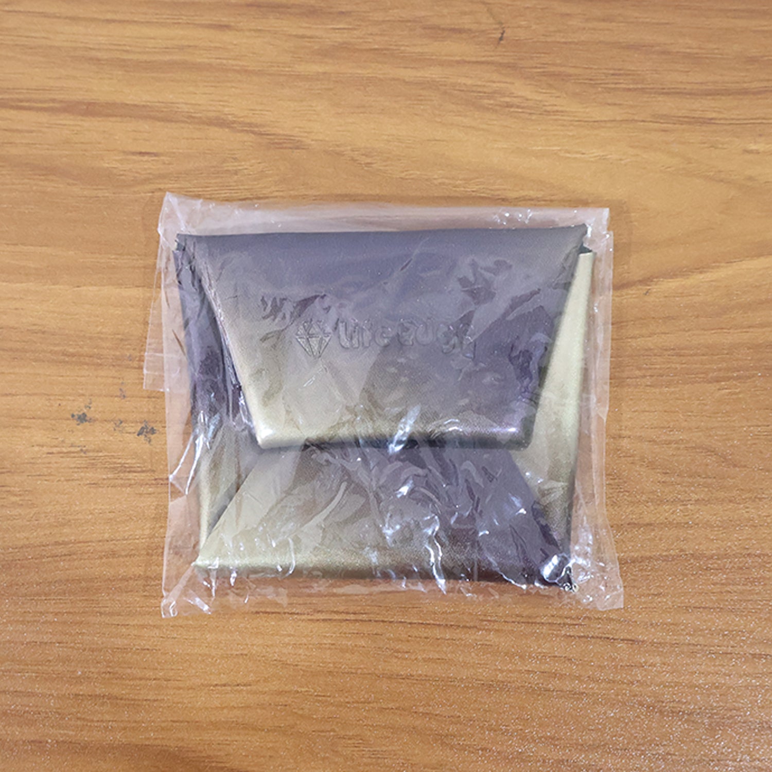 Coin pouch folded compact in hand