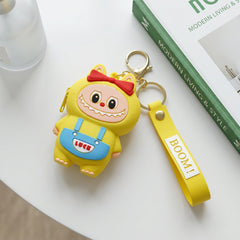 Playful cartoon monster coin purse shown clipped onto a backpack