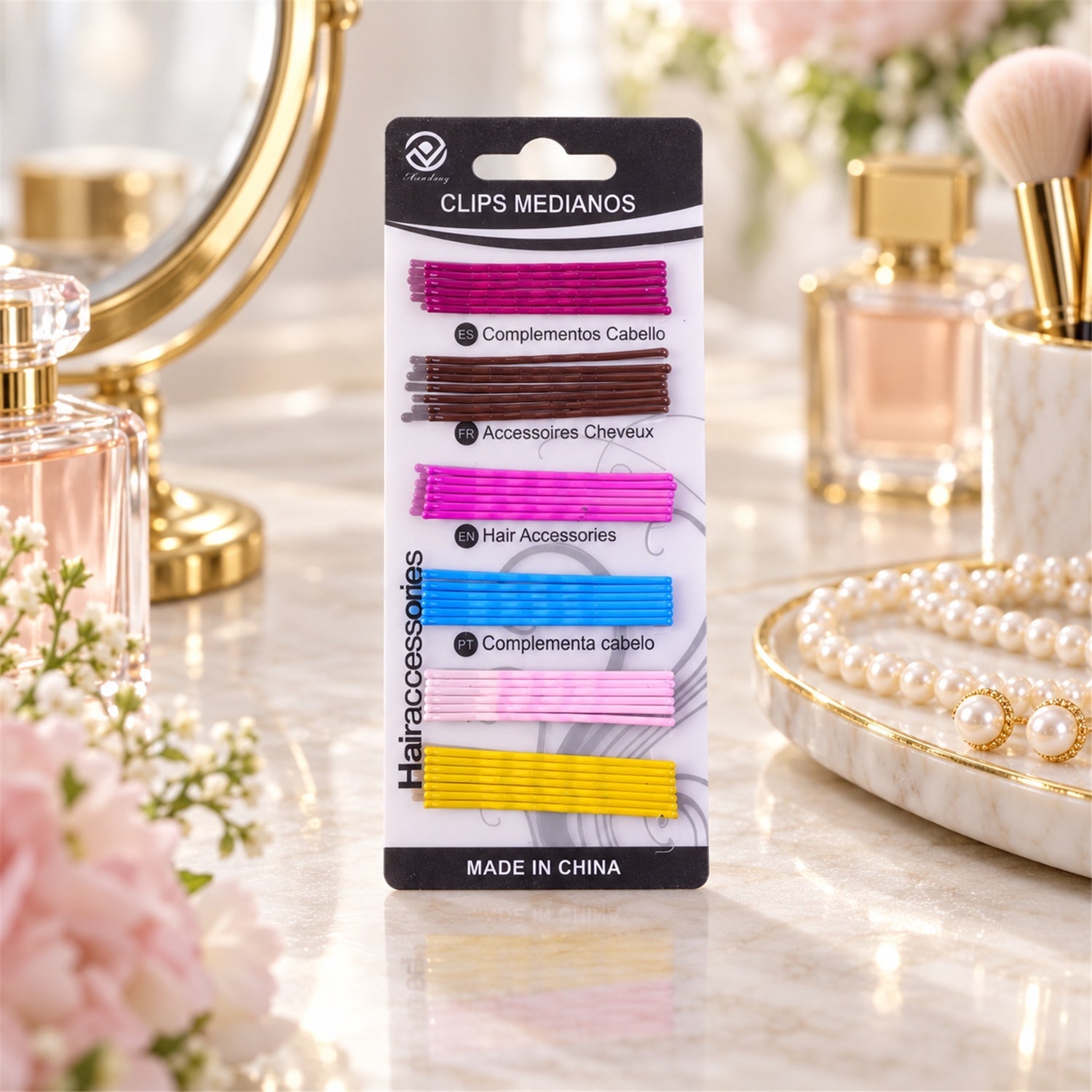A package of colorful bobby pins in various shades, including purple, brown, pink, blue, light pink, and yellow, sits on a