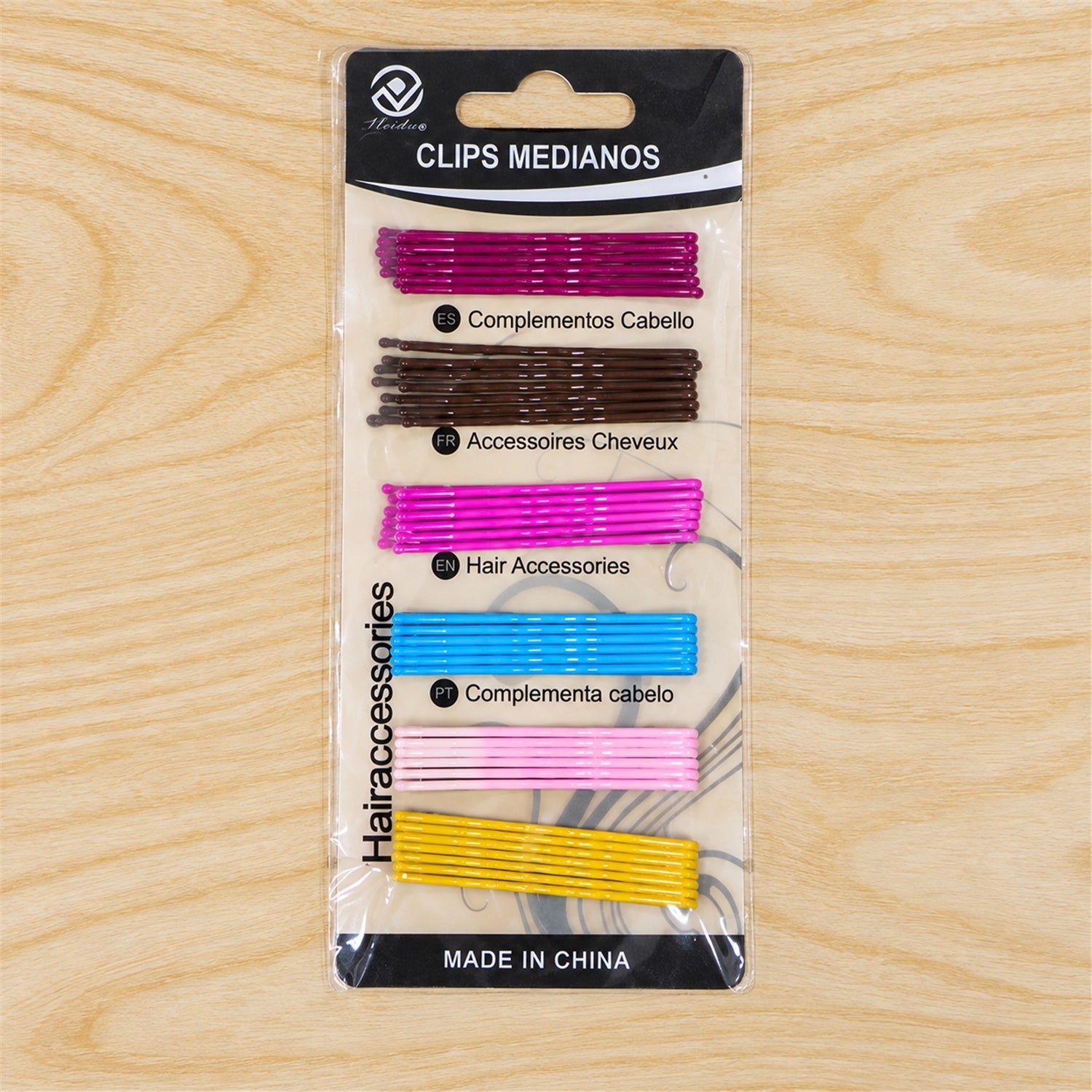 A package of colorful bobby pins, including purple, brown, hot pink, blue, light pink, and yellow, is displayed on a light