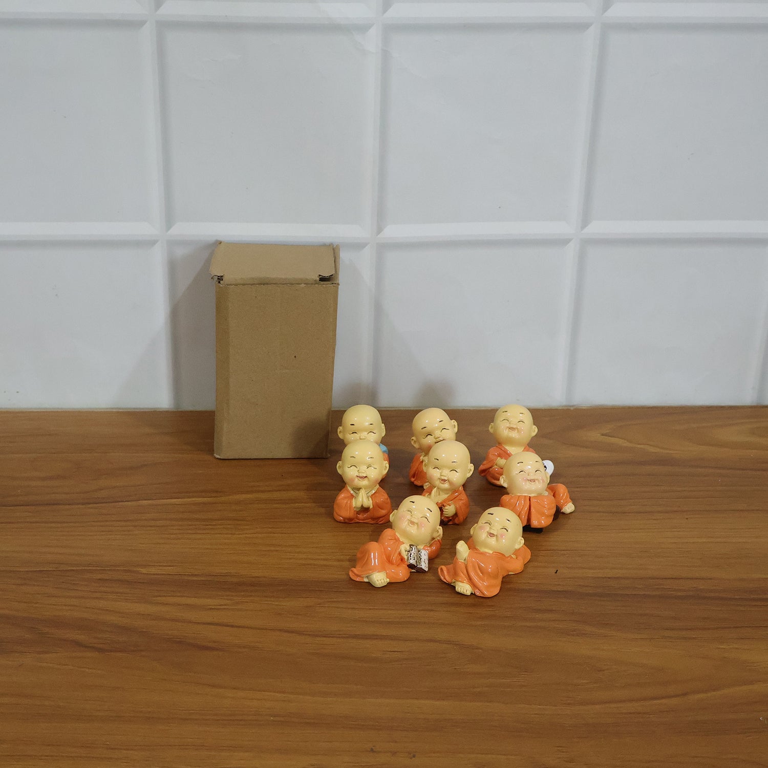 Mini Monk Buddha idol set displayed on a shelf