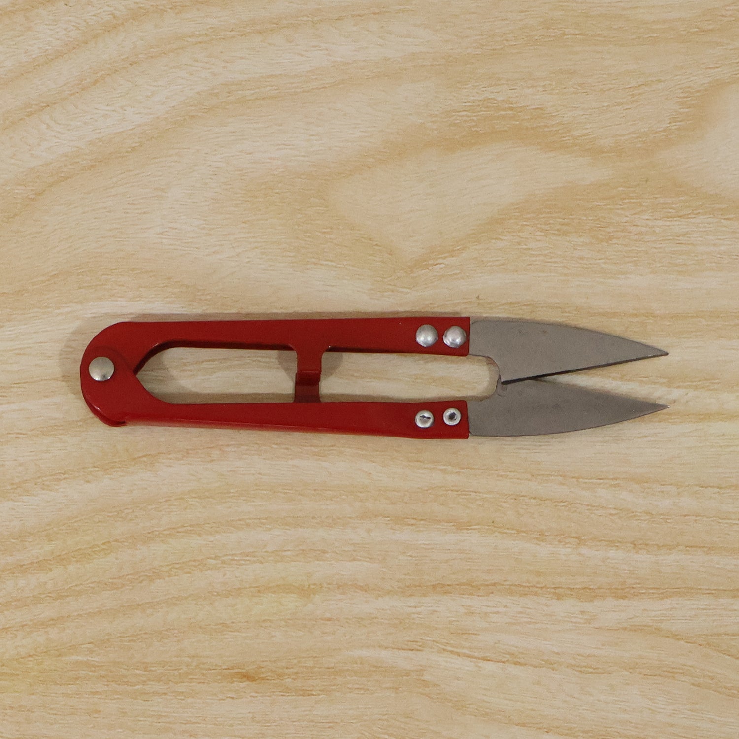 Thread cutter snip scissors angled view showing blades
